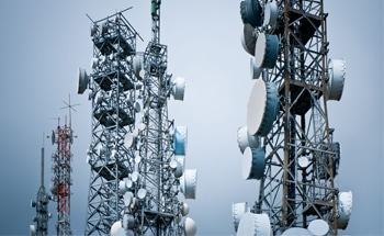 telecommunications towers against a gray sky