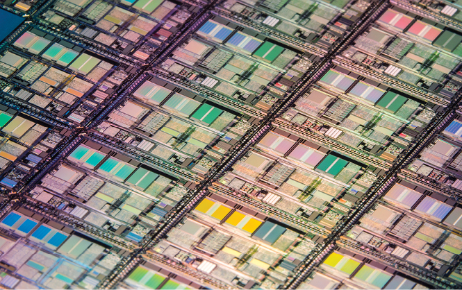 CPU silicon wafer seen at 15x magnification under UV lights 