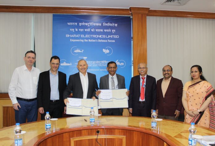 Mr K V Suresh Kumar, Director (Marketing), BEL, and Mr Avi Elisha, VP and General Manager, Missile Systems Division, IAI, display the MoU signed between BEL and IAI, in the presence of Mr Bhanu Prakash Srivastava, CMD, BEL, and other senior officers in Bengaluru yesterday.